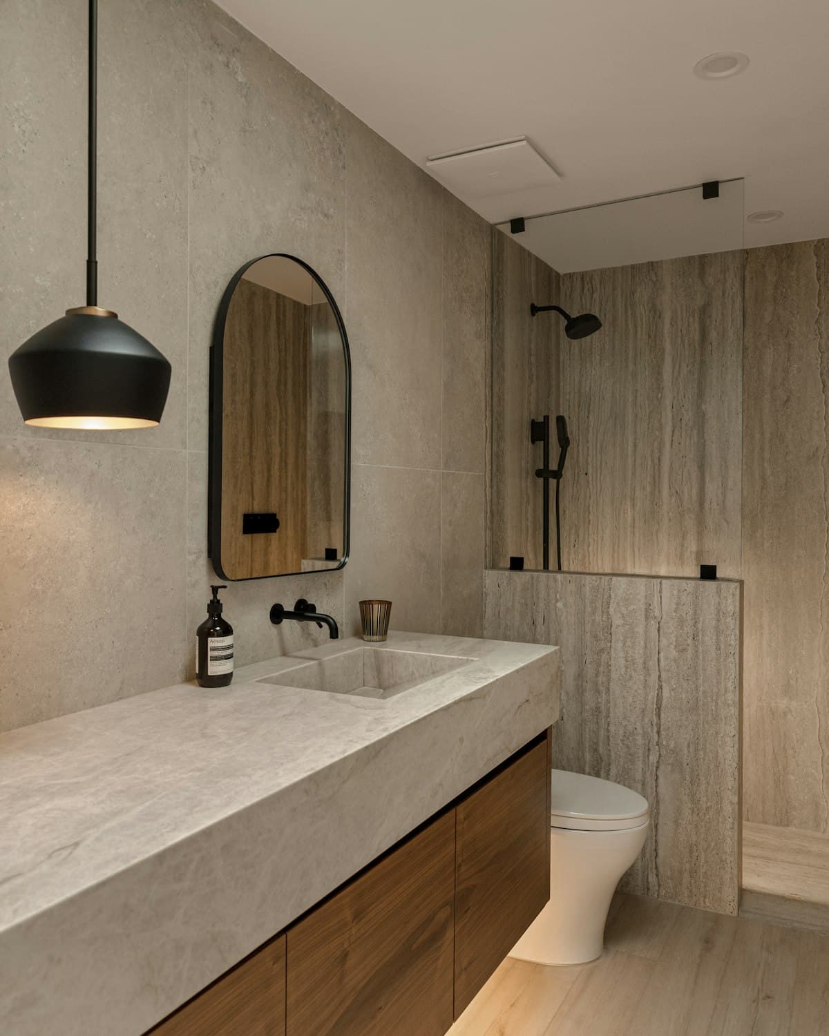 Bathroom in light stone with an oak vanity
