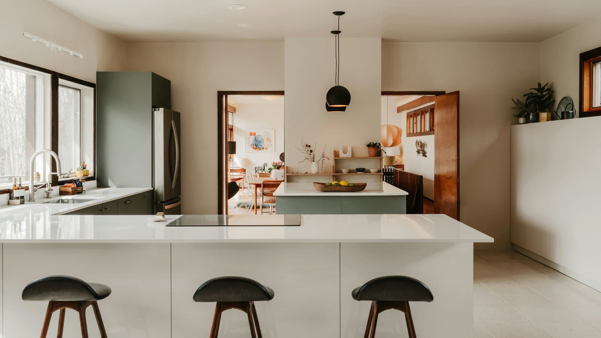 Kitchen with white stone benchtop and light oak joinery