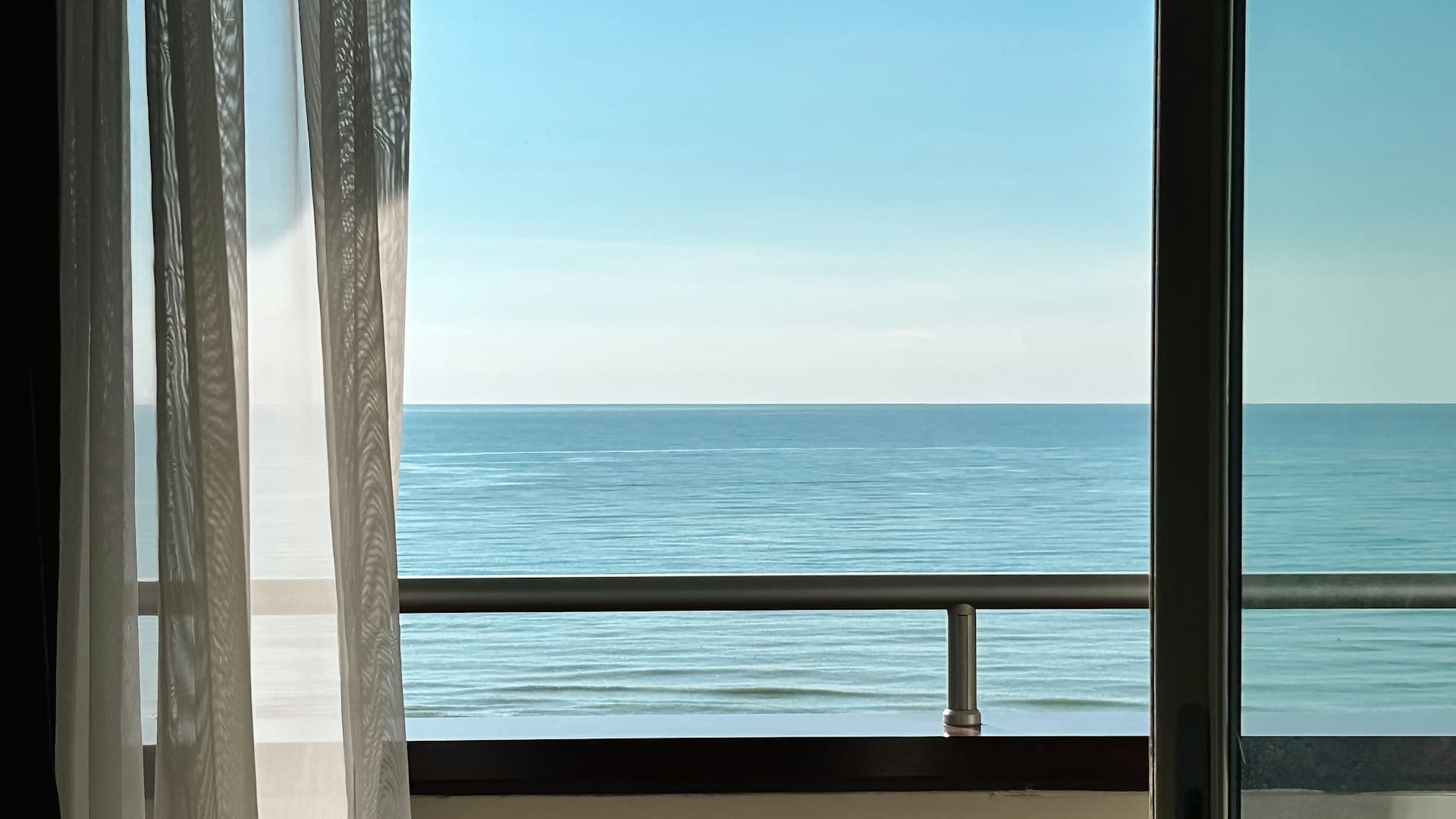 Apartment balcony terrace with chairs and a city view