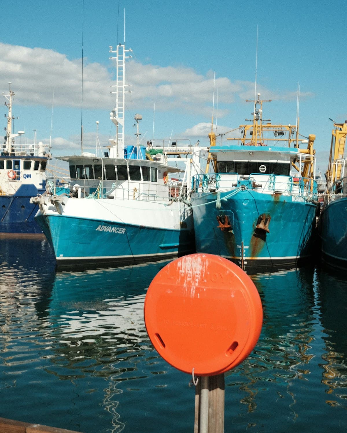 Harbour with fishing boats moored in calm water